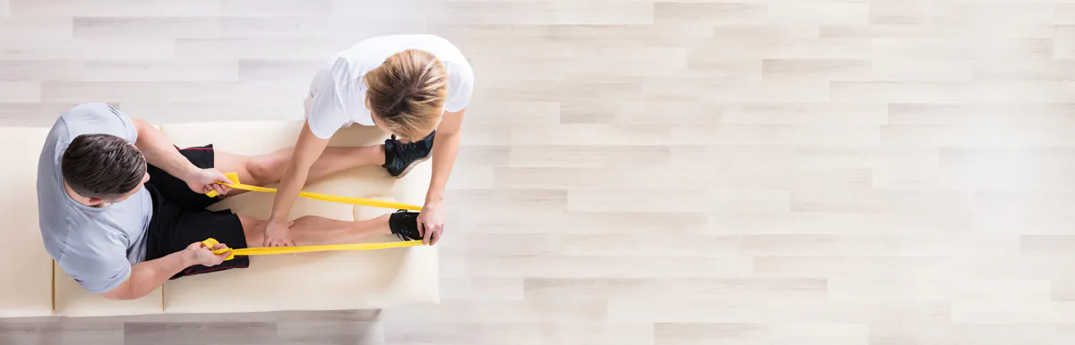 An above view of a physical therapist assisting a patient in a leg stretch in El Paso.